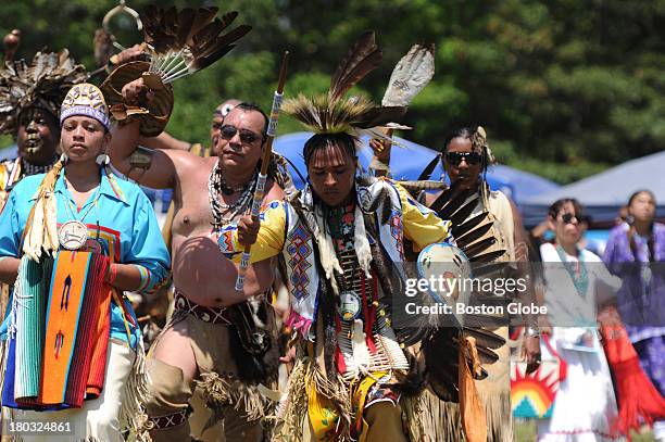 Native Americans enter the arena during the Grand Ceremony of the 92nd Mashpee Wampanoag Powwow at the Barnstable County Fairgrounds in East Falmouth...