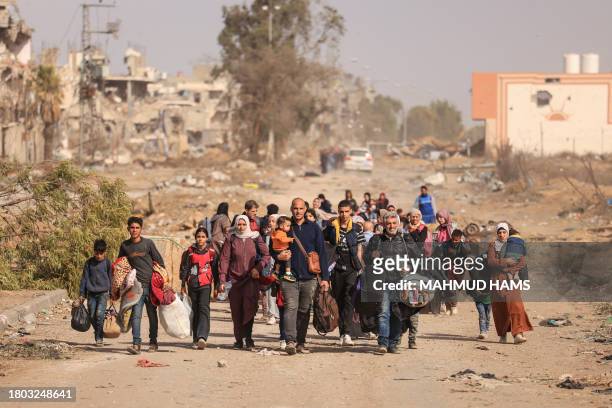 Palestinians fleeing the north walk along the Salaheddin road in the Zeitoun district on the southern outskirts of Gaza City on November 26, 2023....