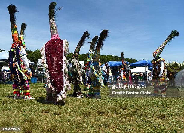 Members of the Warwick Combey Troupe of Bermuda get ready to take part in the 92nd Mashpee Wampanoag Powwow at the Barnstable County Fairgrounds in...