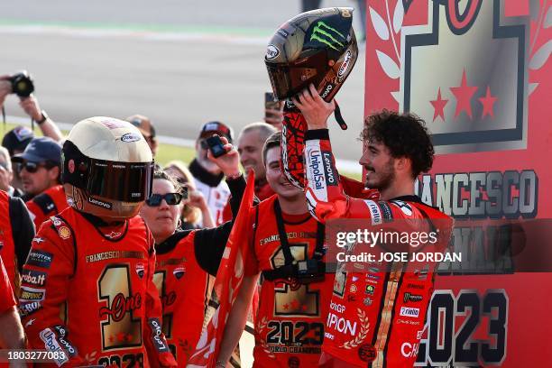 Ducati Italian rider Francesco Bagnaia racts raising his helmet to winning the MotoGP Valencia Grand Prix at the Ricardo Tormo racetrack in Cheste,...