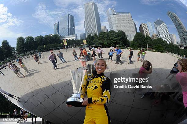 Miss Sprint Cup Brooke Werner holds the Sprint Cup Trophy as she stands next to The Cloud Gate in Millennium Park on September 11, 2013 in Chicago,...