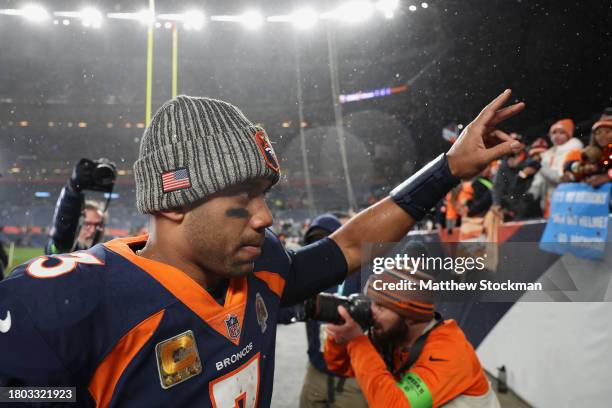 Quarterback Russell Wilson of the Denver Broncos waves to fans after defeating the Minnesota Vikings in the NFL game at Empower Field At Mile High on...