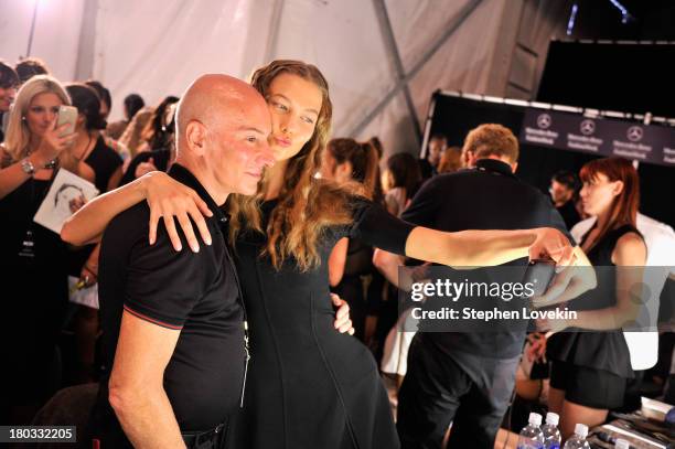 Model Karlie Kloss and stylst Garren prepare backstage at the Anna Sui fashion show during Mercedes-Benz Fashion Week Spring 2014 at The Theatre at...