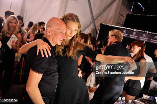 Model Karlie Kloss and stylst Garren prepare backstage at the Anna Sui fashion show during Mercedes-Benz Fashion Week Spring 2014 at The Theatre at...