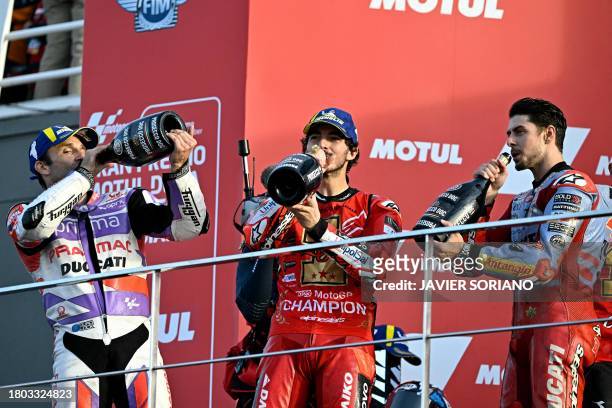 Ducati Italian rider Francesco Bagnaia celebrates on the podium with second-placed Ducati Italian rider Fabio Di Giannantonio and third-placed Ducati...