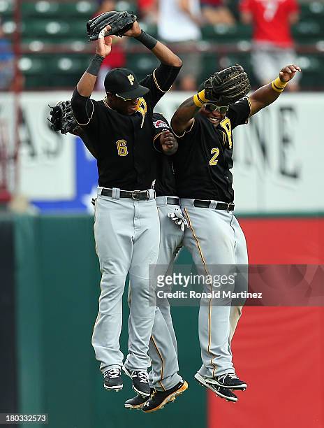Starling Marte, Felix Pie and Marlon Byrd of the Pittsburgh Pirates celebrate a win against the Texas Rangers at Rangers Ballpark in Arlington on...