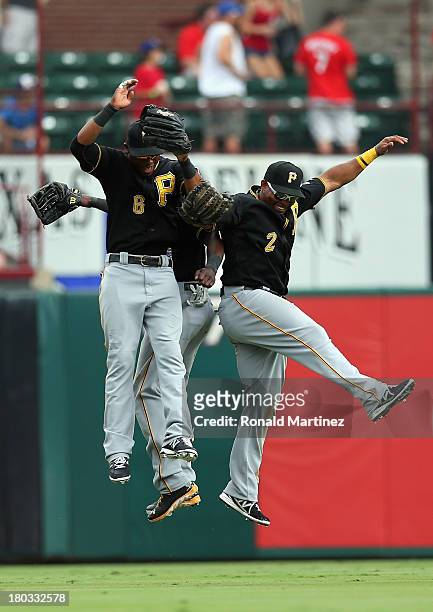 Starling Marte, Felix Pie and Marlon Byrd of the Pittsburgh Pirates celebrate a win against the Texas Rangers at Rangers Ballpark in Arlington on...