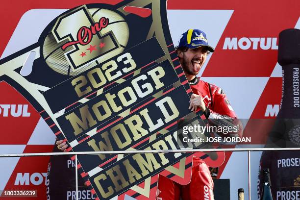 Ducati Italian rider Francesco Bagnaia celebrates on the podium after winning the MotoGP Valencia Grand Prix at the Ricardo Tormo racetrack in...