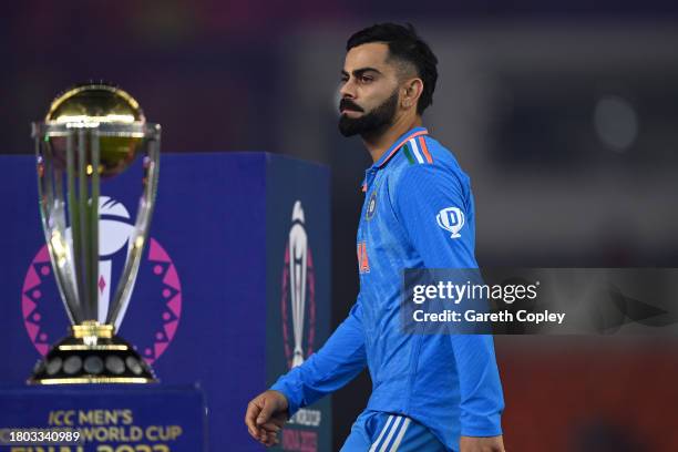 Virat Kohli of India makes their way past the ICC Men's Cricket World Cup Trophy following the ICC Men's Cricket World Cup India 2023 Final between...