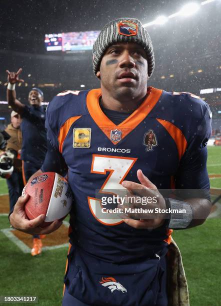 Quarterback Russell Wilson of the Denver Broncos runs off the field after defeating the Minnesota Vikings in the NFL game at Empower Field At Mile...