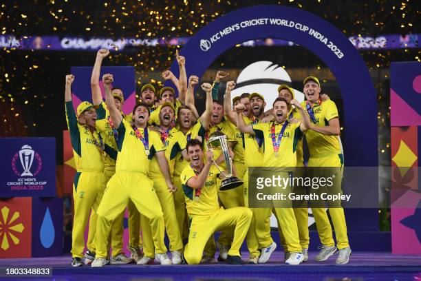 Australia captain Pat Cummins lifts the Cricket World Cup with teammates after winning the ICC Men's Cricket World Cup India 2023 Final between India...