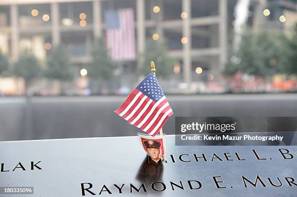 Flag adorns the 9/11 Memorial on the twelfth anniversary of the terrorist attacks on lower Manhattan at the World Trade Center site on September 11,...