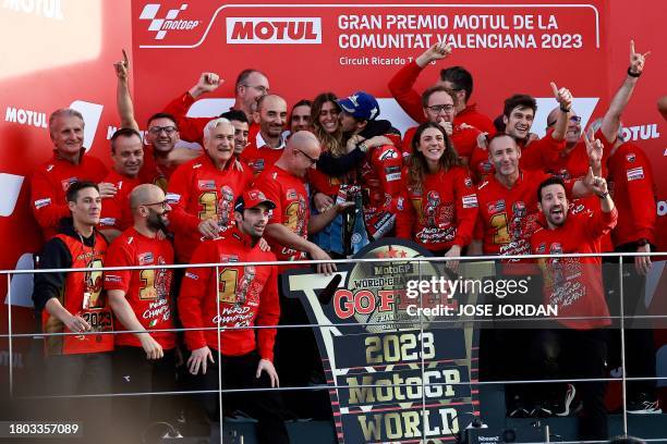 Ducati Italian rider Francesco Bagnaia and his partner Domizia Castagnini celebrate with team members after winning the MotoGP Valencia Grand Prix at...