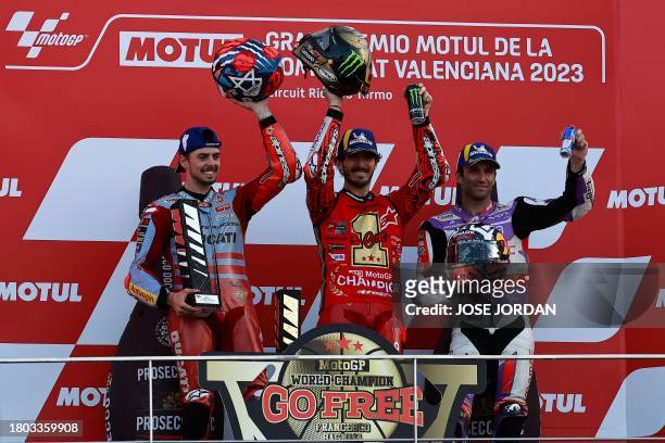 Ducati Italian rider Francesco Bagnaia celebrates on the podium with second-placed Ducati Italian rider Fabio Di Giannantonio and third-placed Ducati...