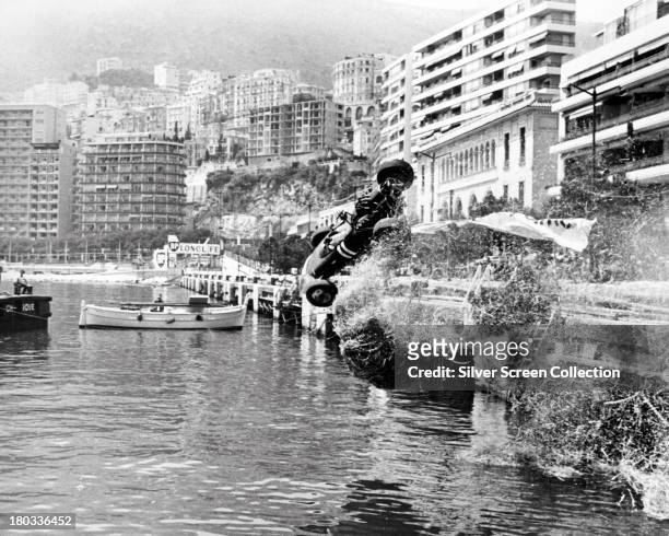 Formula One car crashes during the Monaco Grand Prix in 'Grand Prix', directed by John Frankenheimer, 1966.