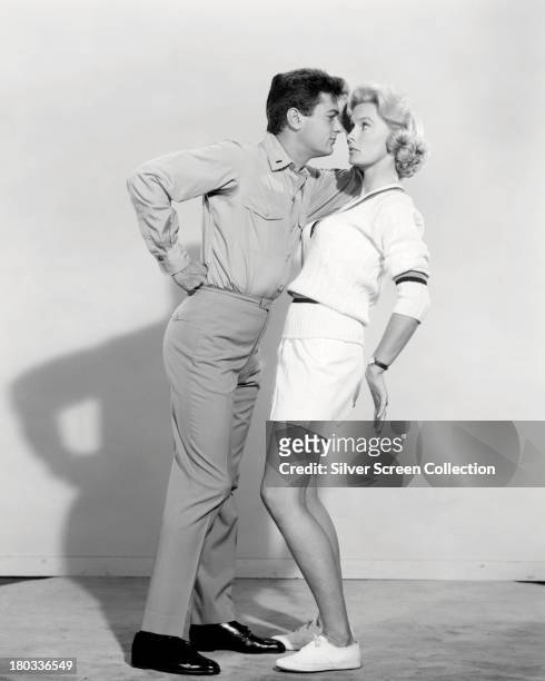 American actors Tony Curtis and Dina Merrill in a promotional portrait for 'Operation Petticoat', directed by Blake Edwards, 1959.