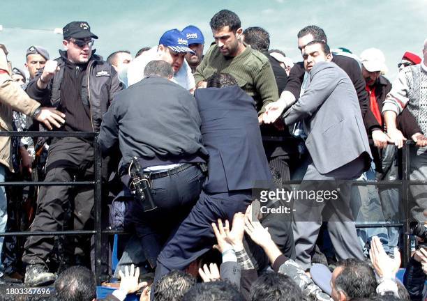Saad Hariri , son of slain former Lebanese prime minister Rafiq Hariri, is helped by security officers and bodyguards to get on the podium during a...