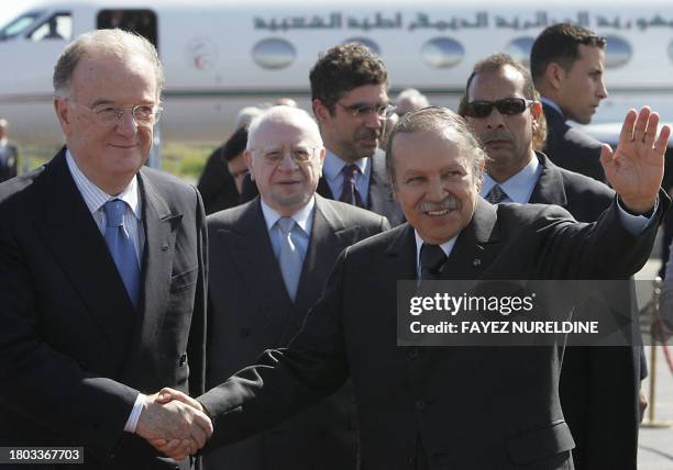 Algerian President Abdelazziz Bouteflika escorts his Porugalese counterpart Jorge Fernando Sampaio at the Algiers Houari Boumediene airport 04 March...