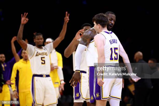 Austin Reaves of the Los Angeles Lakers celebrates his three-point basket with teammate LeBron James during the fourth quarter against the Houston...