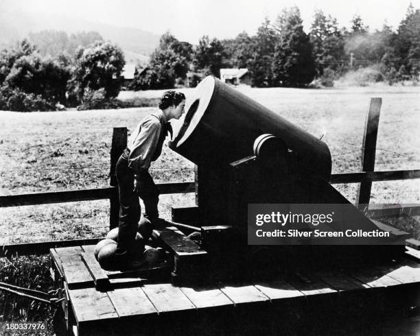 American comic actor and filmmaker Buster Keaton on an artillery car in a scene from 'The General', directed by Keaton, 1926.