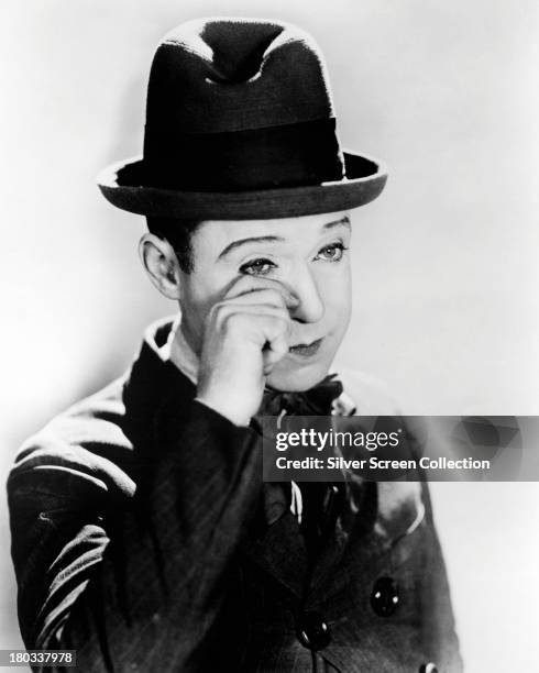 American silent film comedian Harry Langdon wiping away a tear, circa 1925.