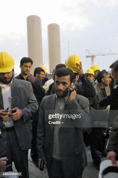 Iranian President Mahmoud Ahmadinejad talks on his mobile phone during a tour of the Bushehr nuclear power plant, 01 February 2006. Iran's hardline...