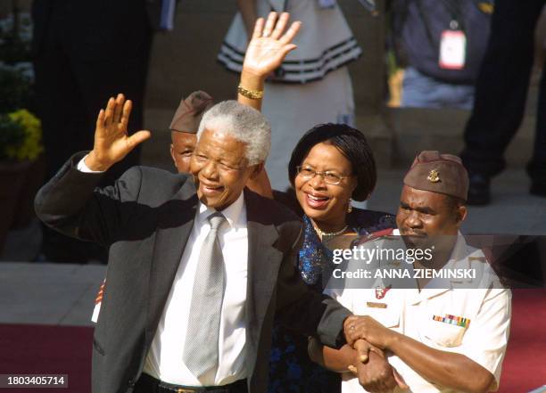 Former South African President Nelson Mandela , accompanied by his wife Graca , arrives at the Union Buildings in Pretoria 27 April 2004 for the...