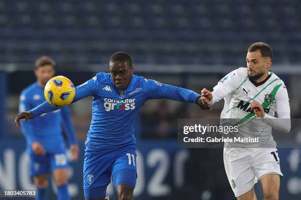 Emmanuel Quartsin Gyasi of Empoli FC battles for the ball with Nedim Bajrami of US Sassuolo during the Serie A TIM match between Empoli FC and US...