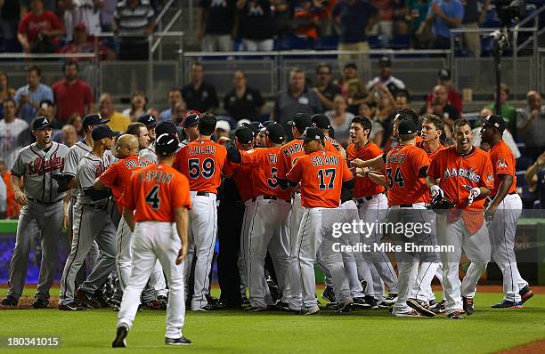 Jose Fernandez of the Miami Marlins reacts to a fight after he hit a solo home run in the sixth inning during a game against the Atlanta Braves at...