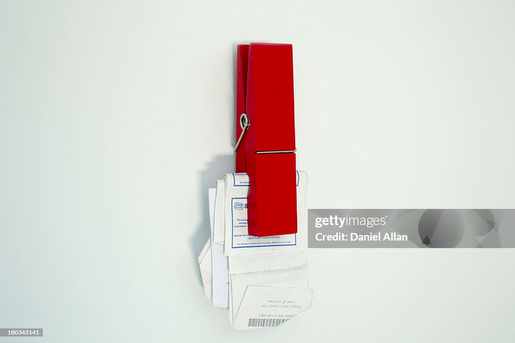 Red peg with receipts and bills