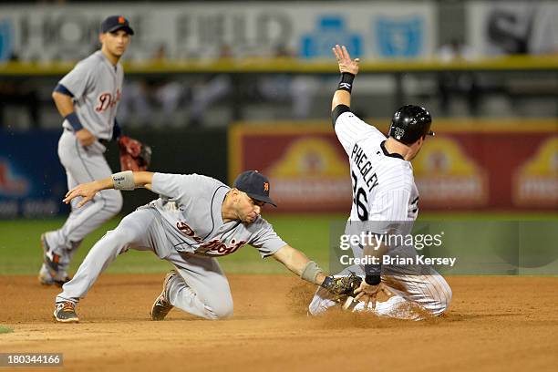 Josh Phegley of the Chicago White Sox steals second base as second baseman Omar Infante of the Detroit Tigers puts on a late tag during the fifth...