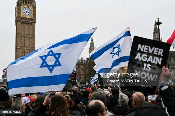 Protesters wave Israeli flags and hold placards in front of Elizabeth Tower, commonly known as Big Ben, at the Houses of Parliament, in central...