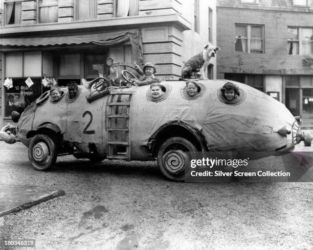 Child cast members, riding in their unusual homemade car, in a promotional still for 'Edison, Marconi & Co.', a Hal Roach 'Our Gang' short, silent...