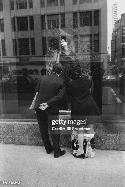 Couple admire a dress in the window of Bergdorf Goodman, 5th Avenue, New York City, 1973.