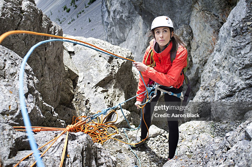 Women feeding out rope while climbing a mountain