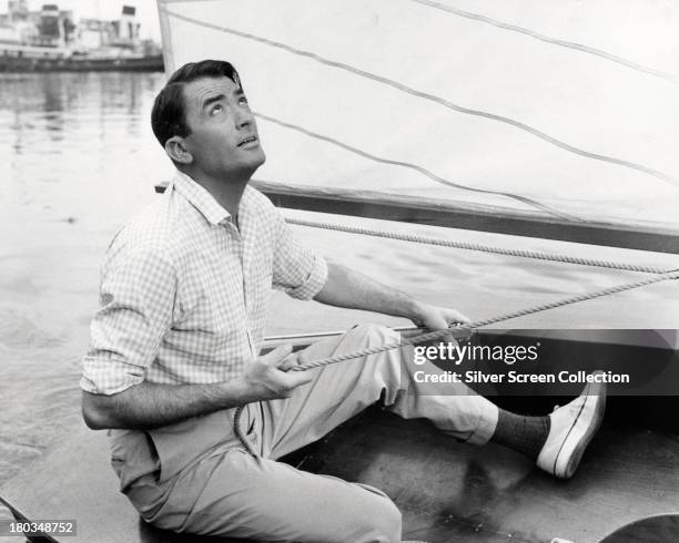 American actor Gregory Peck on a sailing boat, circa 1955.
