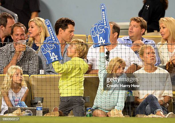 Actress Gwyneth Paltrow and Moses Martin and Apple Martin watch the game between the Arizona Diamondbacks and the Los Angeles Dodgers at Dodger...