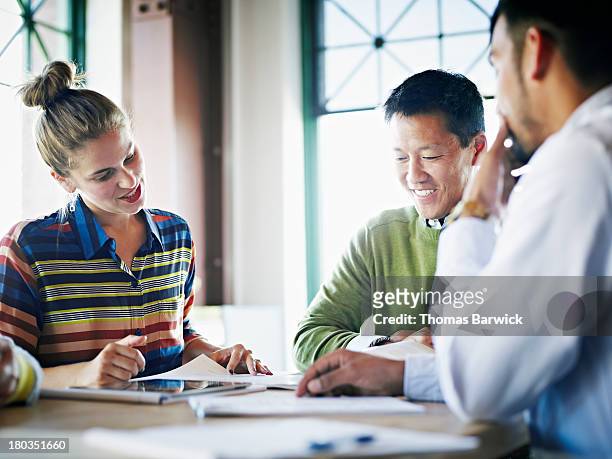 coworkers discussing project in conference room - market research stock pictures, royalty-free photos & images