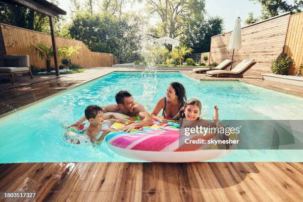 cheerful family having fun during summer day in the pool. - simbassäng bildbanksfoton och bilder