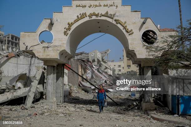 November 2023, Palestinian Territories, Gaza City: A Palestinian man walks out of the destroyed Palestinian Legislative Council in Gaza City, on the...