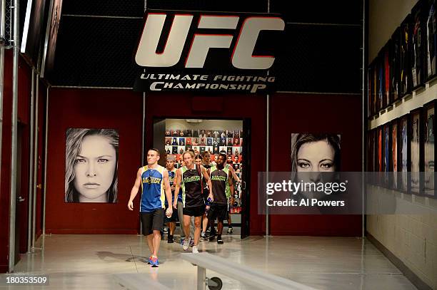 Team Rousey and team Tate walk into the TUF gym prior to Julianna Pena v Shayna Baszler in their preliminary fight during filming of season eighteen...