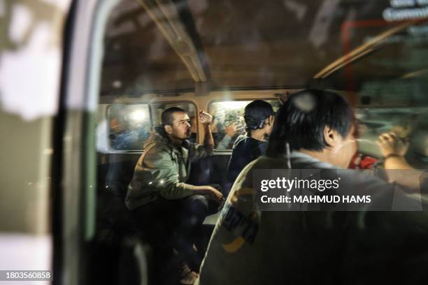 An International Red Cross vehicle carrying Thai hostages released by Hamas drives towards the Rafah border point with Egypt ahead of their transfer...