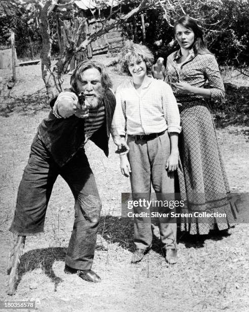 American actor Kirk Douglas, as Peg, and English actors Mark Lester, as Jamie, and Lesley-Anne Down as Lucy-Ann, in 'Scalawag', directed by Douglas,...