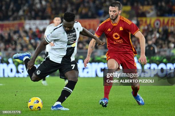 Udinese's Nigerian forward Isaac Success fights for the ball with Roma's Italian midfielder Bryan Cristante during the Italian Serie A football match...