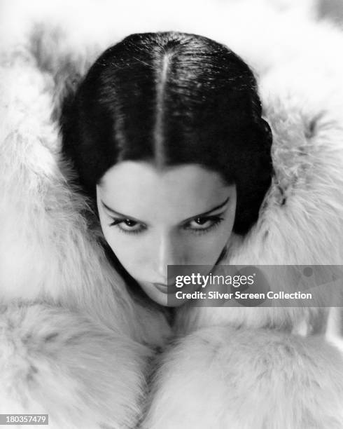 Mexican actress Lupe Velez ensconced in a white fur, circa 1930. (Photo by Silver Screen Collection/Getty Images