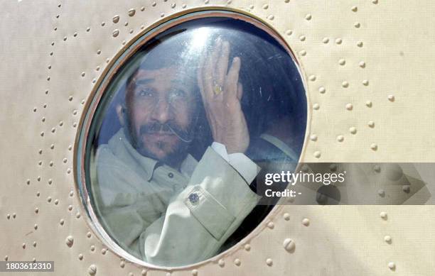 Iranian President Mahmoud Ahmadinejad waves to well-wishers as his helicopter prepares to leave the city of Khaf, near the holy city of Mashhad in...