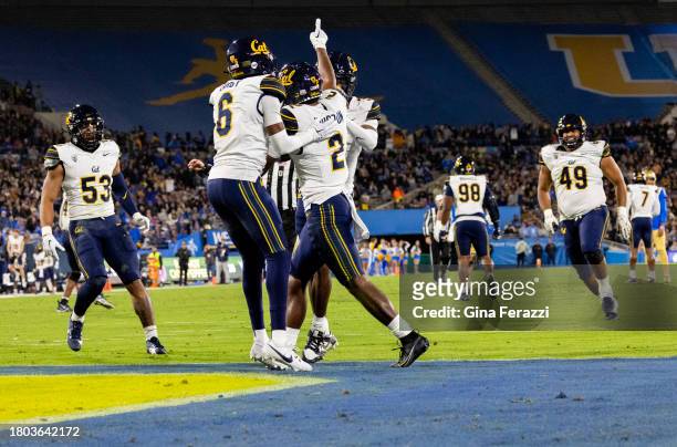 California Golden Bears defensive back Craig Woodson reacts with teammates after intercepting a pass thrown by UCLA Bruins quarterback Dante Moore in...