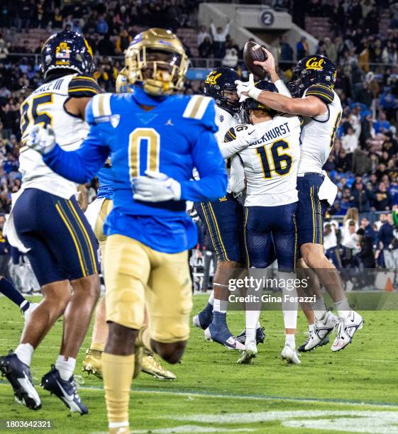 Teammates swarm California Golden Bears place kicker Michael Luckhurst after he recovered a fumble by UCLA Bruins running back Colson Yankoff on a...