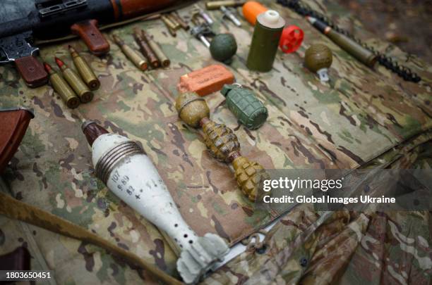 Automatic rifles, shells and grenades lie on a table during a military exercise on November 11, 2023 in Kyiv, Ukraine. Fighters of the 3rd Separate...