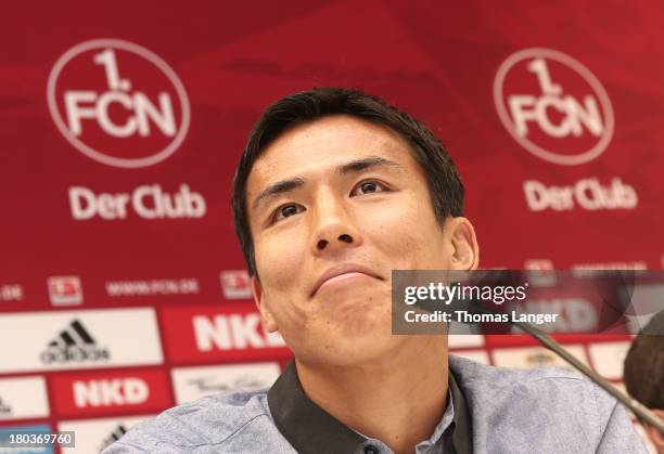 New Player Makoto Hasebe of FC Nuernberg smiles during a press conference at Sportpark Valznerweiher on September 12, 2013 in Nuremberg, Germany.